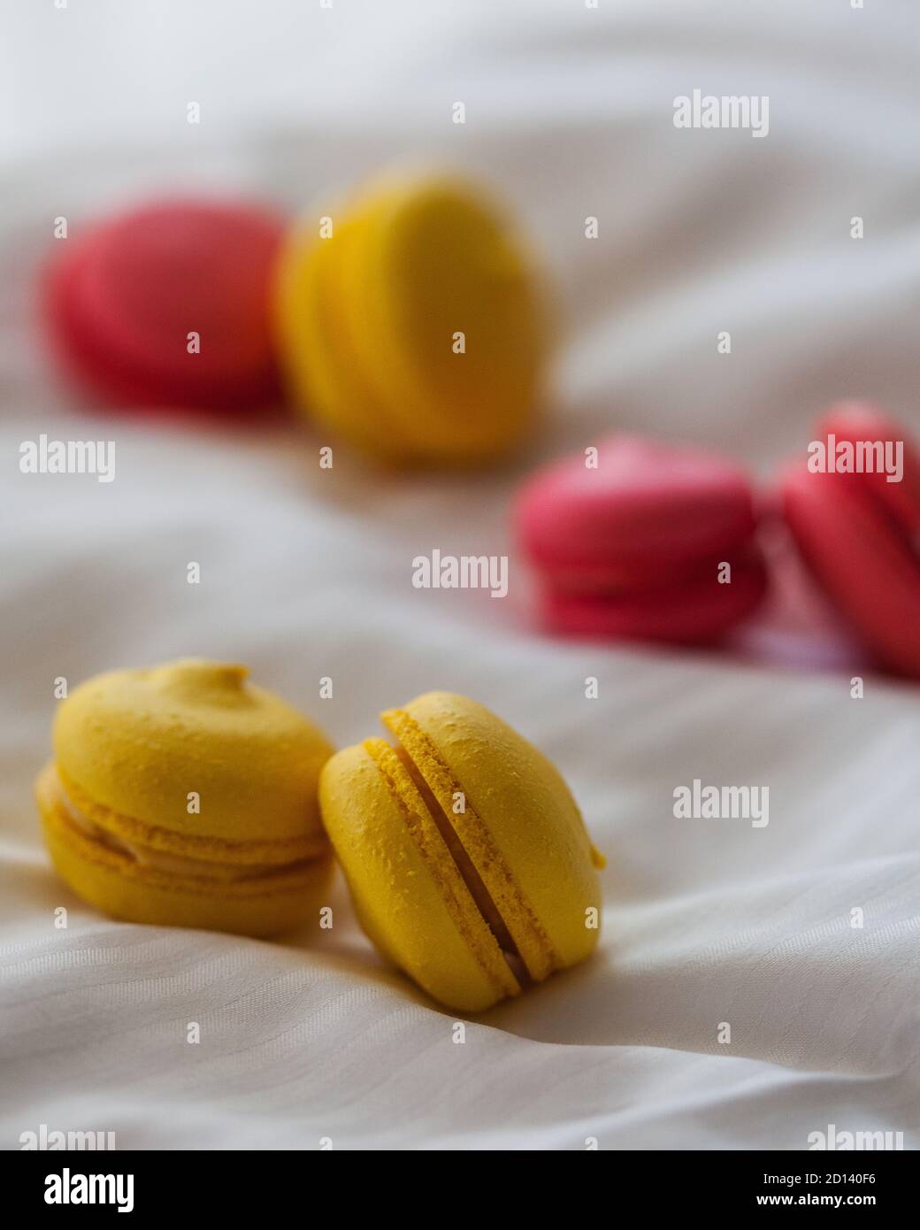 Colorful macaroon cakes on white background. Yellow and red macaroons