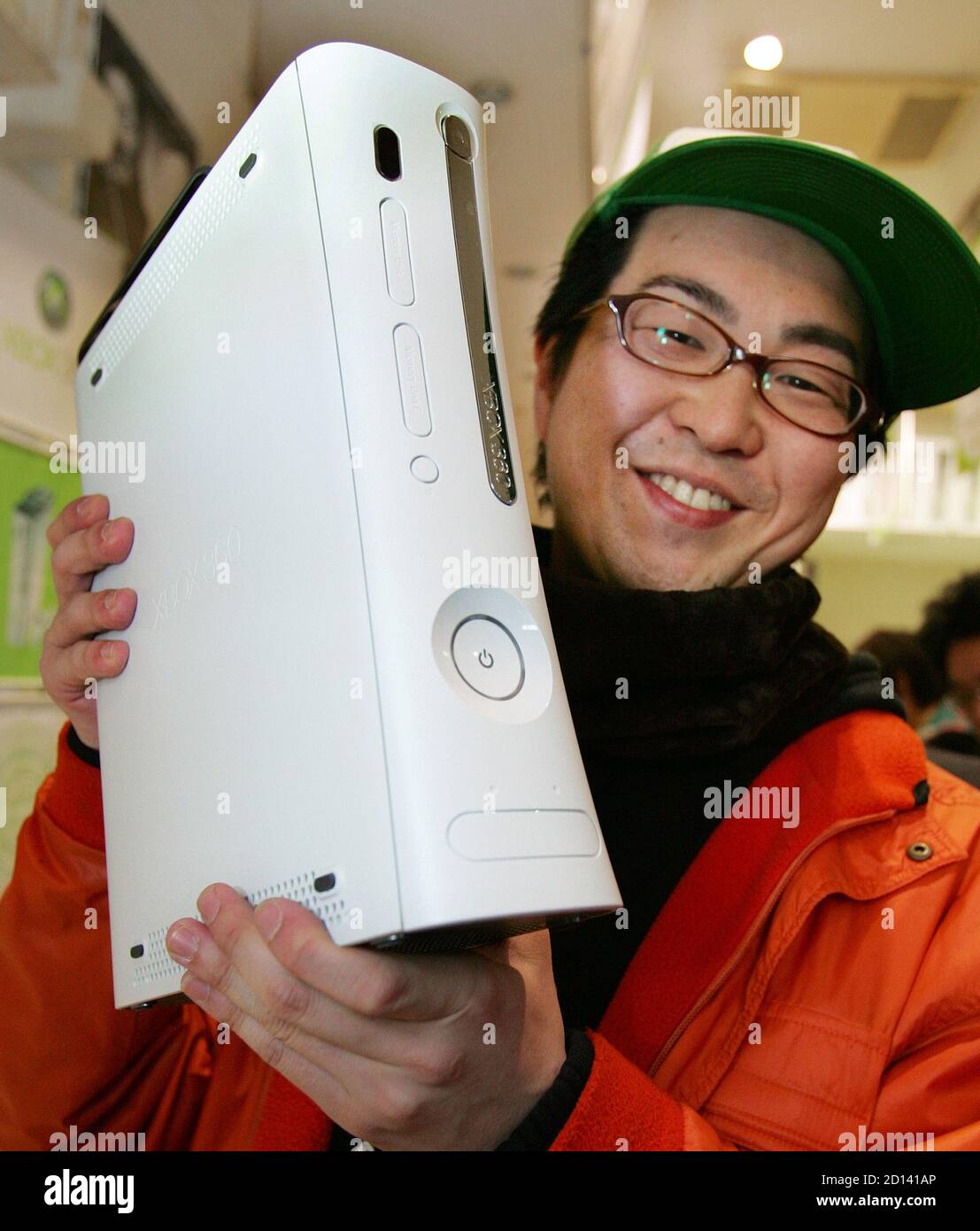 A Japanese Customer Shows Off His Newly Purchased Microsoft Corp S Xbox 360 Video Game Console After Its Early Morning Launch In Tokyo December 10 05 Microsoft Corp Begins Selling Its New Xbox