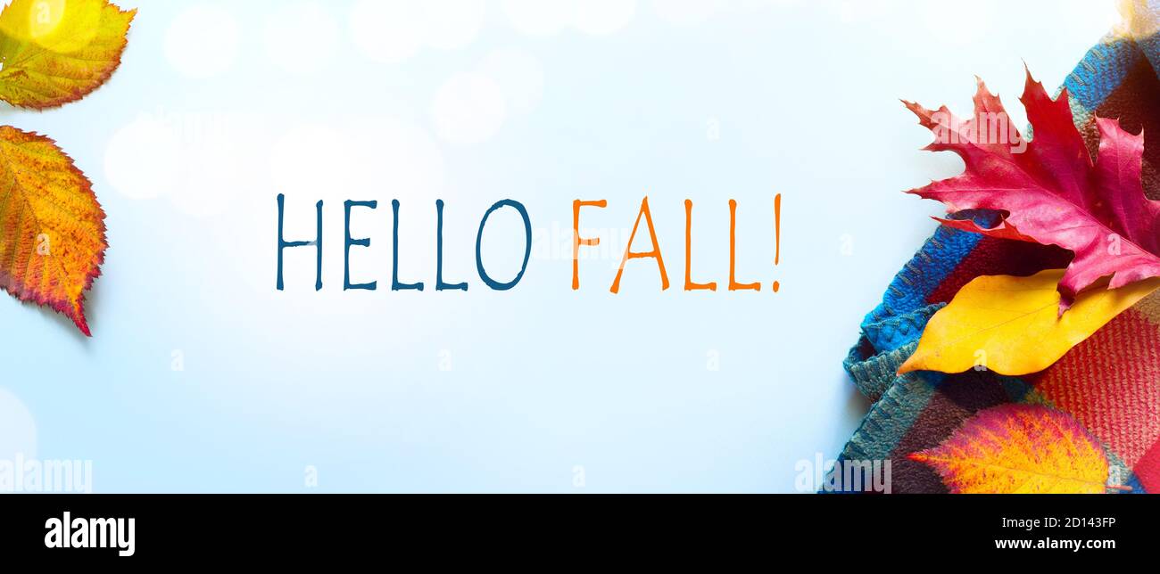 Hello fall message with Autumn leaves and Warm scarf on a blue ...
