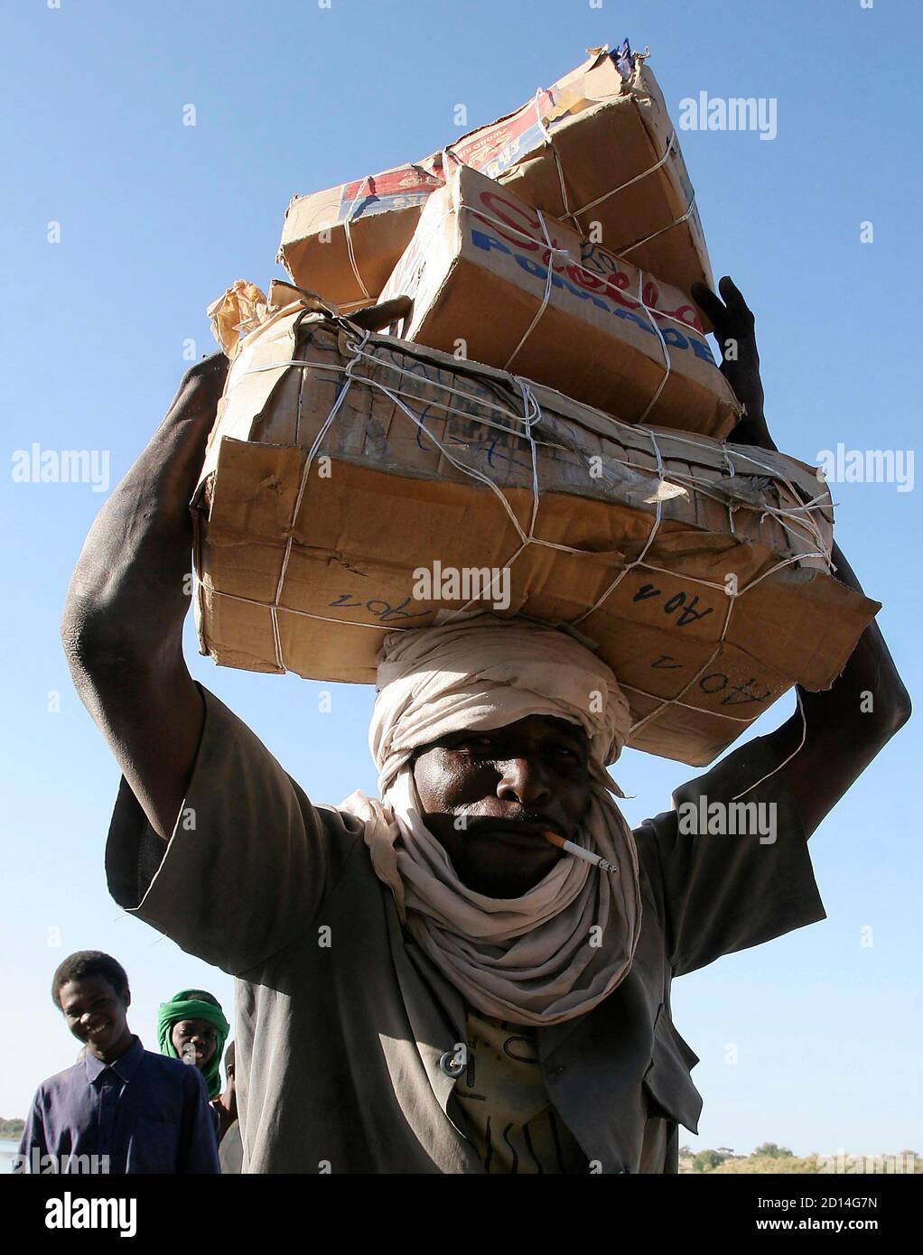 A man carries goods from a pirogue coming from Nigeria in Bol, Chad,  January 27, 2007. Bol is the main city on the shores of Lake Chad and a  trading centre for