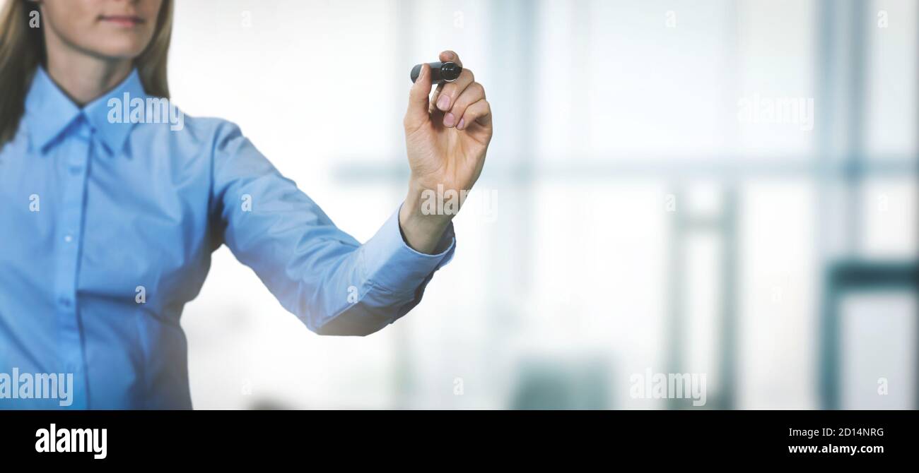 woman write something with black marker on office background. banner copy space Stock Photo