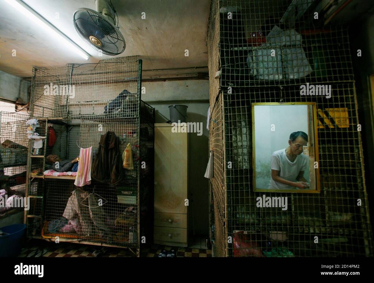 People rest at one of about 100 cage homes in Hong Kong March 20, 2009. The  monthly rent of a caged-bed, the lowest standard for a shelter in Hong Kong  besides sleeping