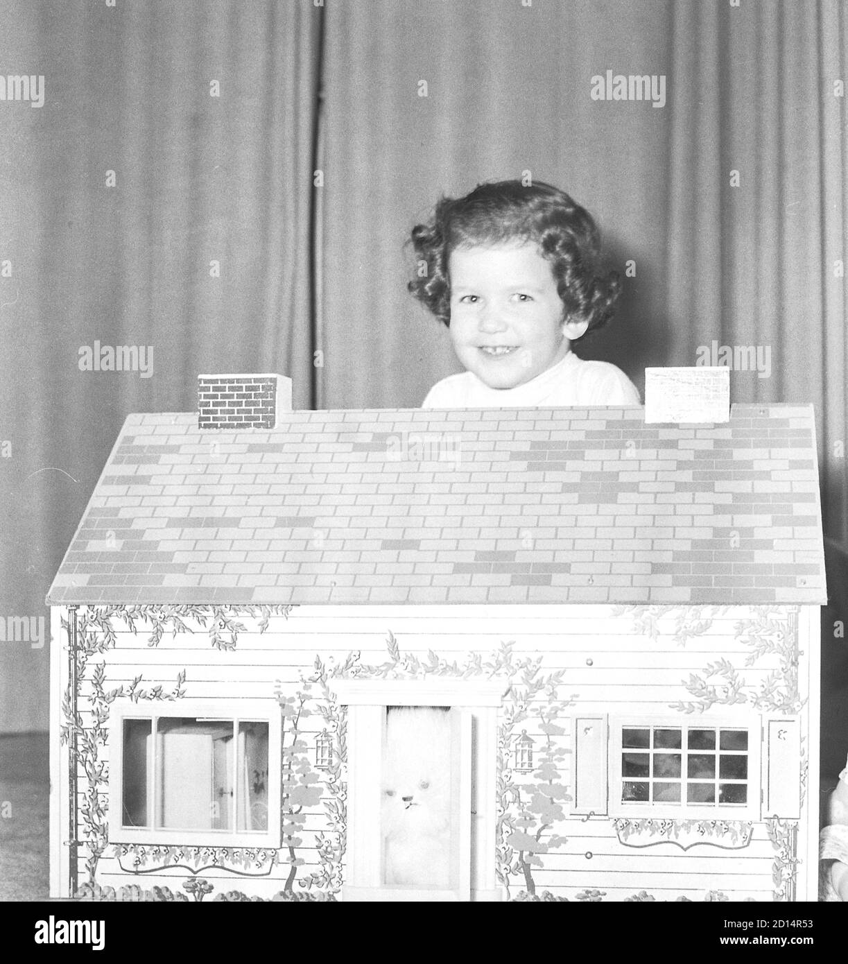 Young girl plays with her dollhouse, USA 1950s Stock Photo - Alamy