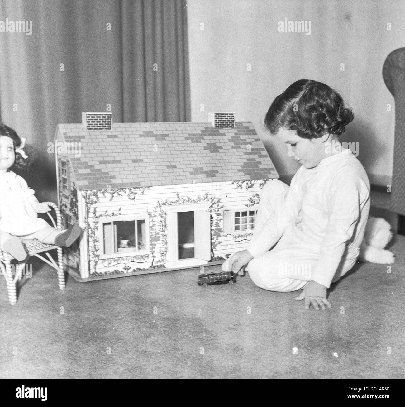 Young girl plays with her dollhouse, USA 1950s Stock Photo - Alamy