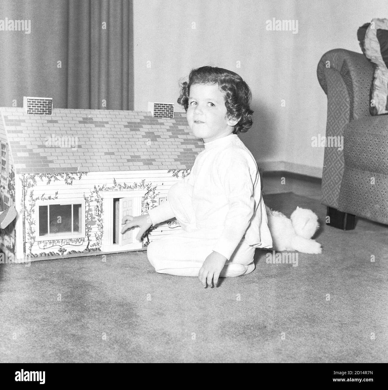 Young girl plays with her dollhouse, USA 1950s Stock Photo - Alamy