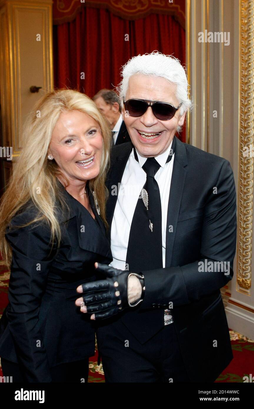 Ricky Lauren (L), wife of U.S. fashion designer Ralph Lauren, reacts as she  dances with German fashion designer Karl Lagerfeld following a ceremony at  the Elysee Palace in Paris April 15, 2010.
