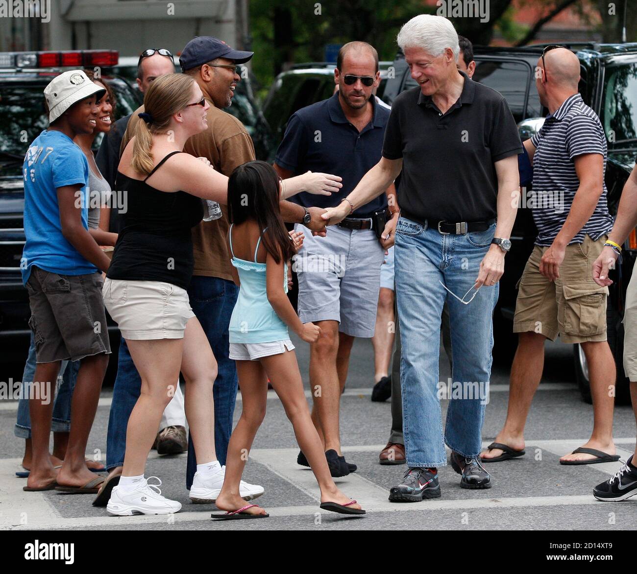 Former U.S. president Bill Clinton greets supporters as he gets out of a  vehicle in Rhinebeck, New York July 30, 2010. With a day to go before  Chelsea Clinton's multimillion-dollar wedding, the