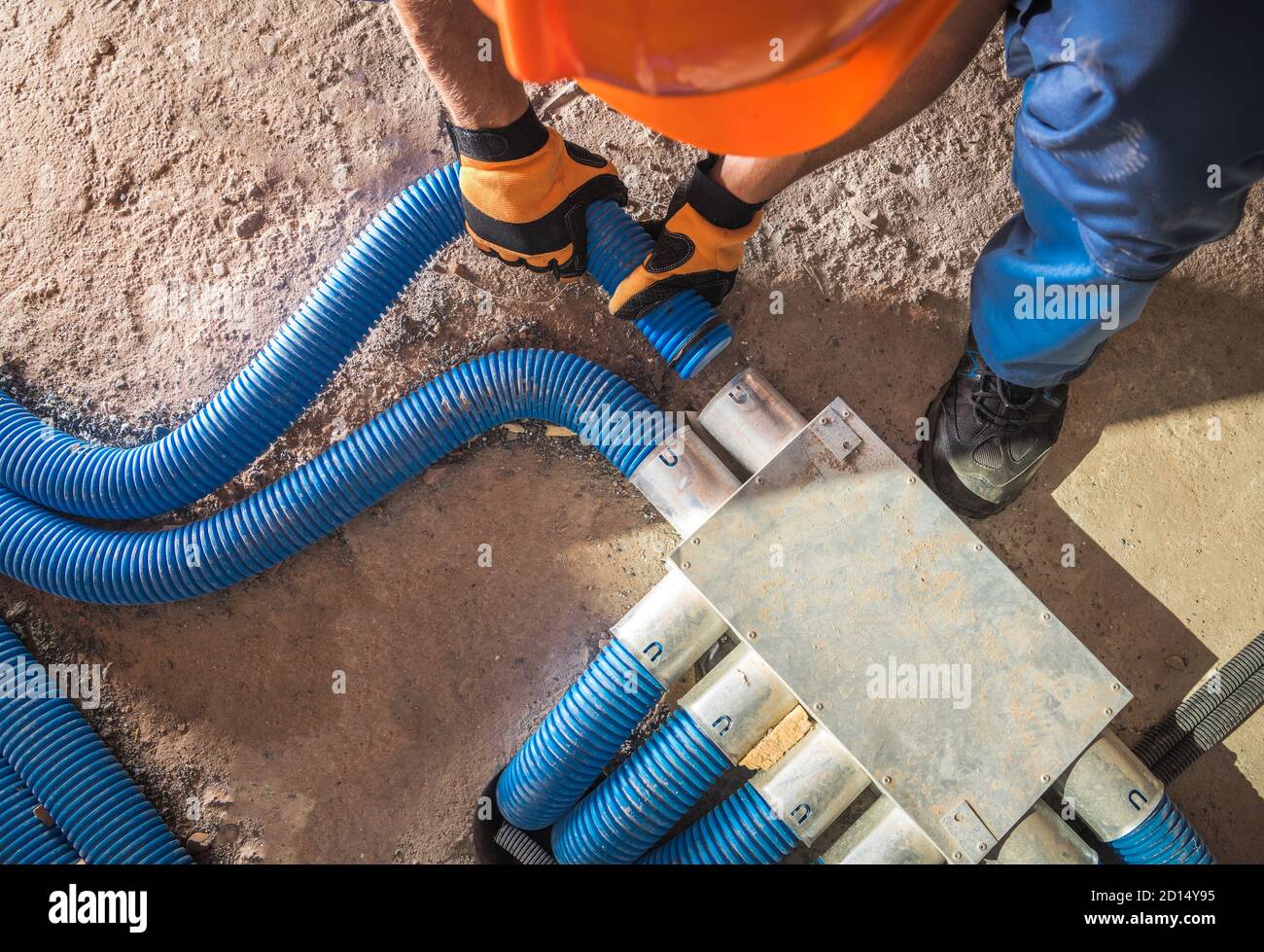 Industrial Theme. Modern Floor Hidden Air Circulation and Climate Control Pipeline Installation. Pipes Hub Finishing by Caucasian Climate Control Tech Stock Photo