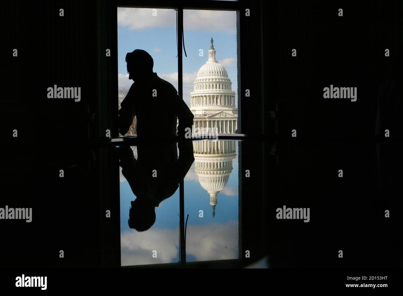 Elmer Eusman and the Capitol building are reflected in the glass encasement for the map that first used the name 'America' at the Library of Congress in Washington December 3, 2007. The 500-year-old map, created by German monk Martin Waldseemuller, is the only known surviving copy and was purchased for $10 million in 2003.    REUTERS/Jim Young   (UNITED STATES) Stock Photo