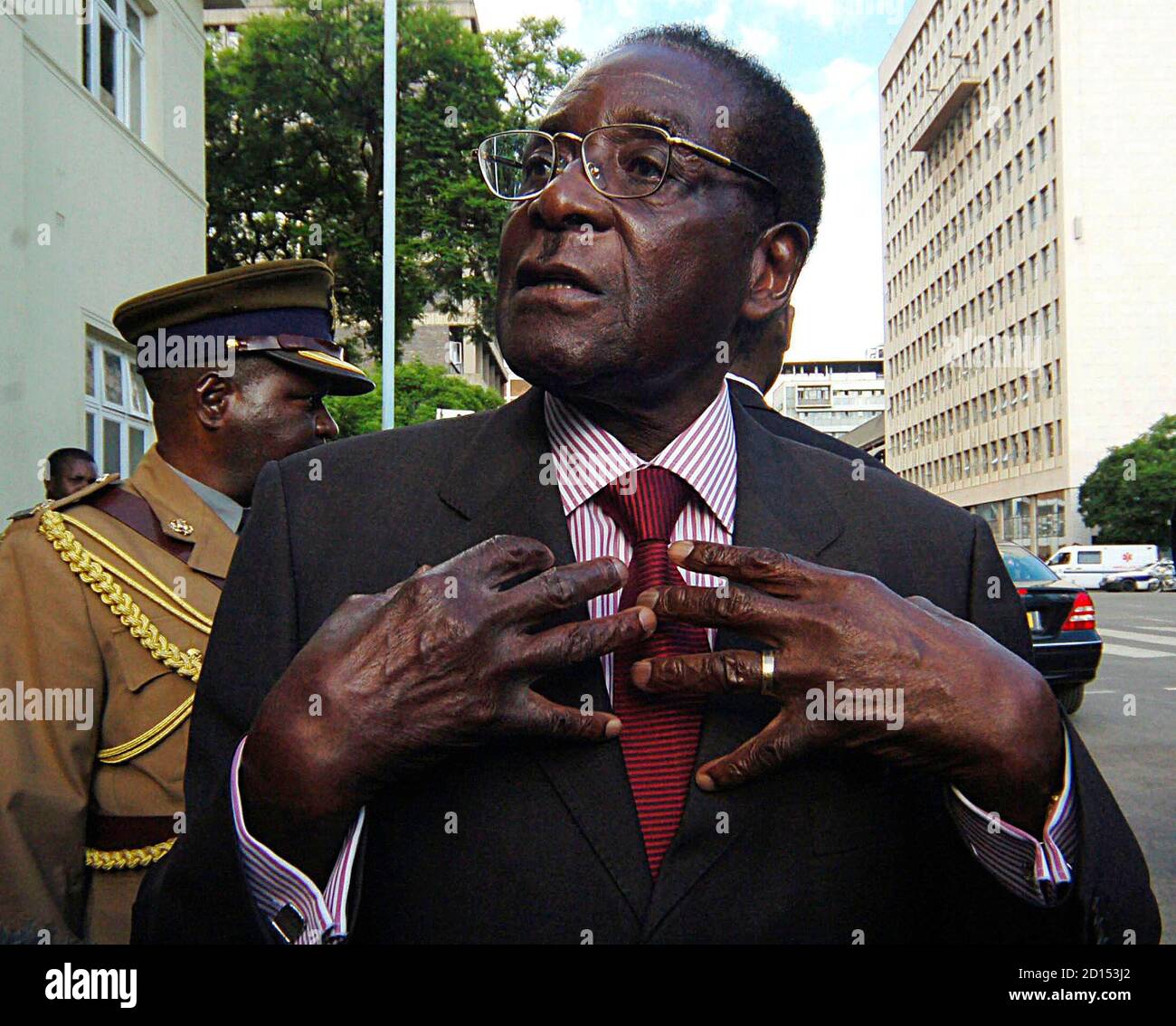 Zimbabwe's President Robert Mugabe speaks to journalists outside Parliament in Harare December 4, 2007. Mugabe said on Tuesday British efforts to isolate Zimbabwe were crumbling after London failed to have him excluded from an EU-Africa summit. REUTERS/Philimon Bulawayo (ZIMBABWE) Stock Photo