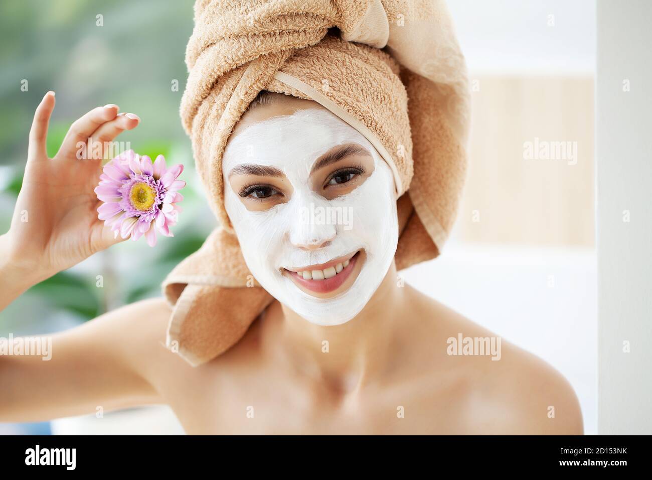 Attractive funny woman with a clay mask on her face Stock Photo - Alamy