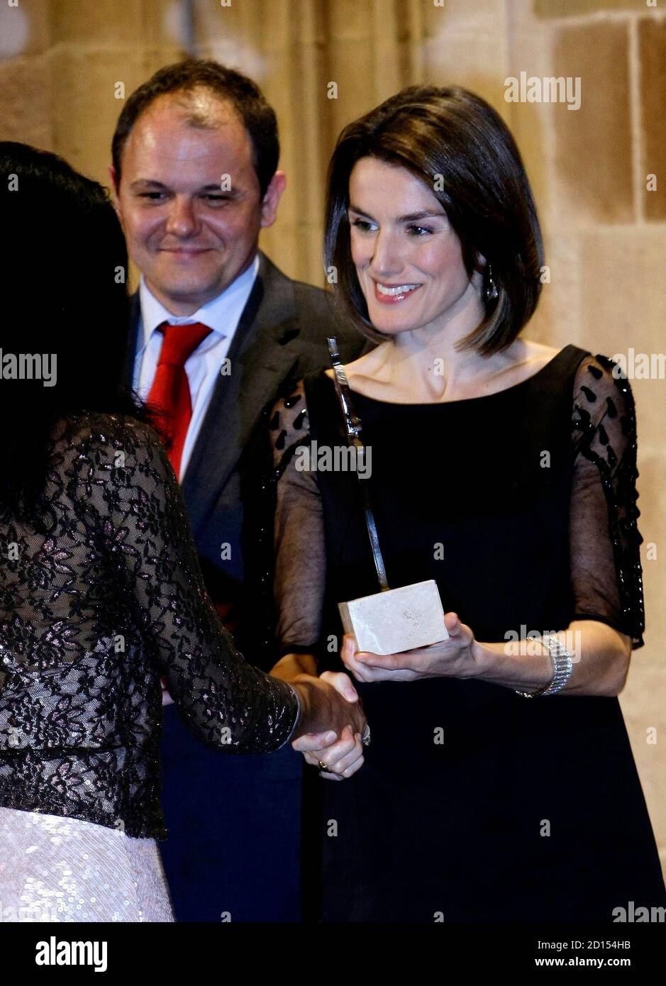 Spain's Princess Letizia presents an award to Montse Nzang (L) for her company's creation of micro credit, at the FIDEM awards for enterprising women, at Casa Llotja de Mar in Barcelona March 26, 2008.     REUTERS/Gustau Nacarino  (SPAIN) Stock Photo