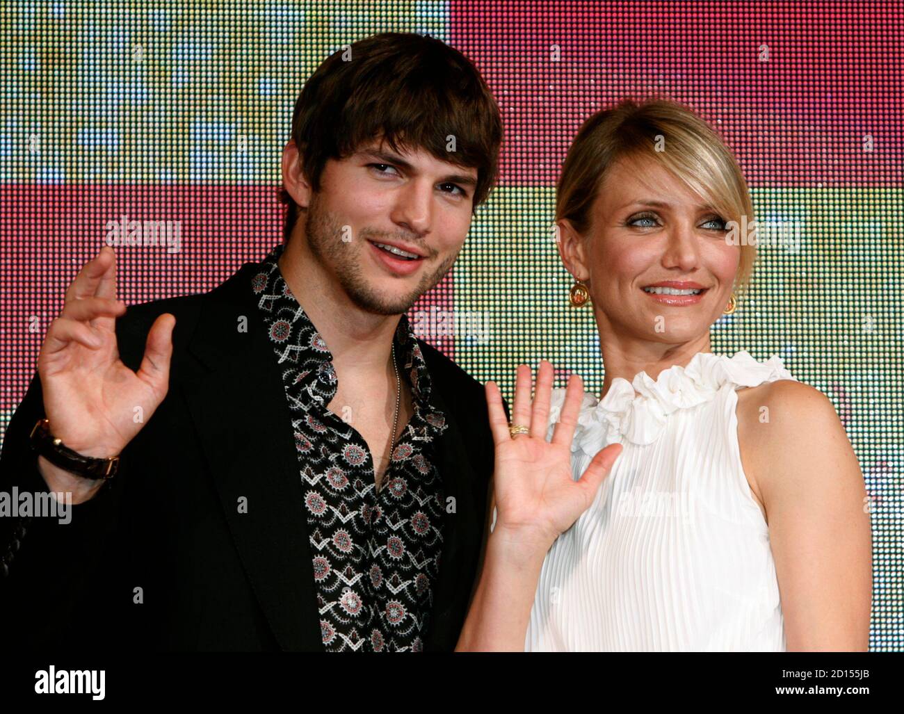 Actress Cameron Diaz (R) and actor Ashton Kutcher wave