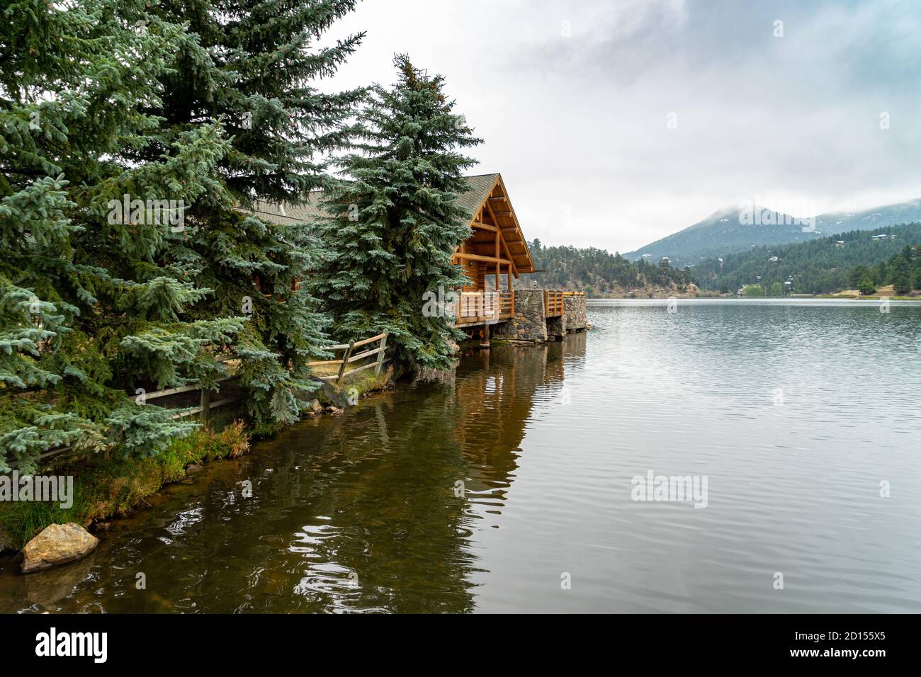 A log building and evergreen trees by Evergreen lake in Colorado. Stock Photo
