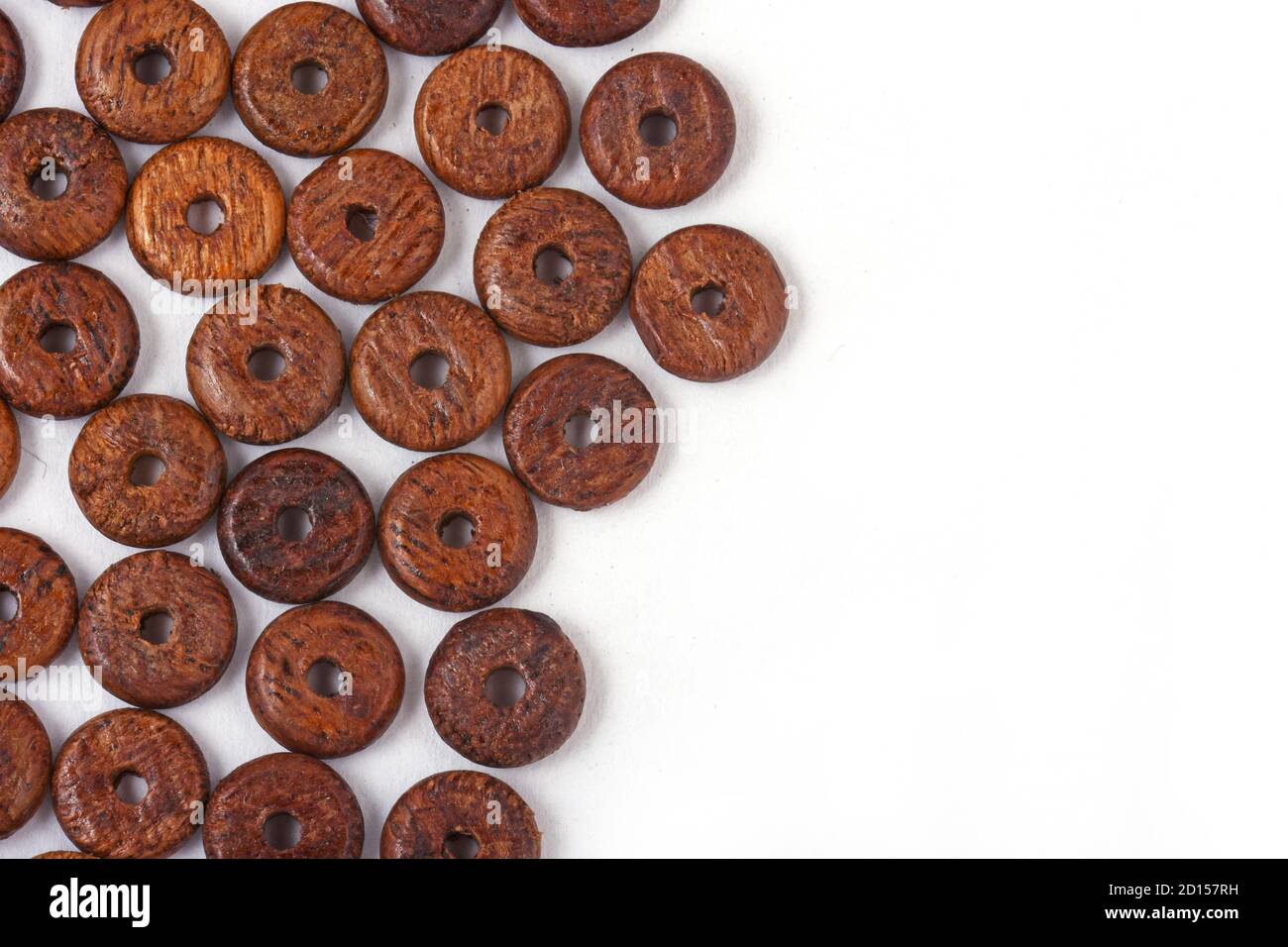 Wooden beads on white background. Top view. Stock Photo