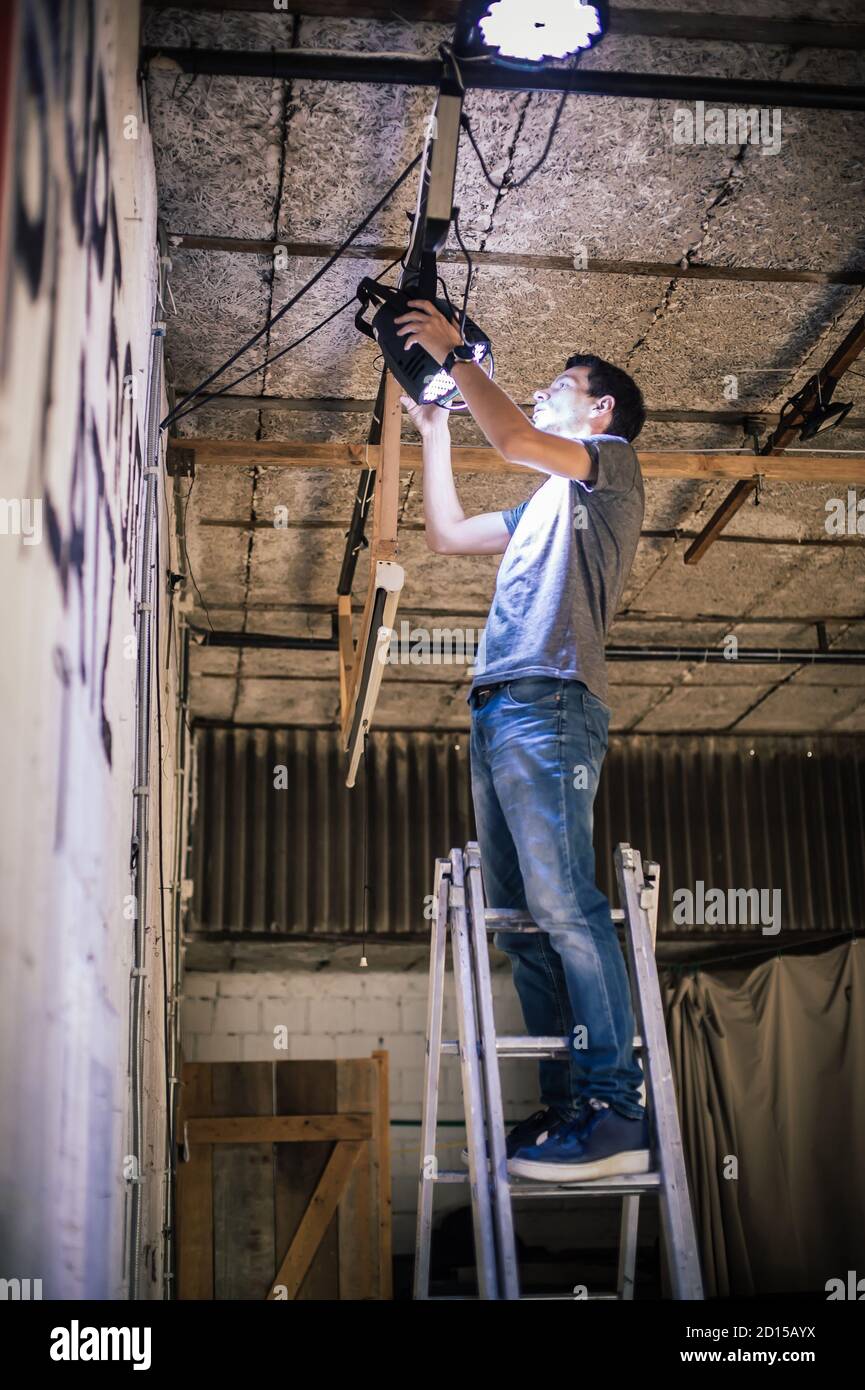 Behind the scene Lighting technician electric engineer adjusting stage