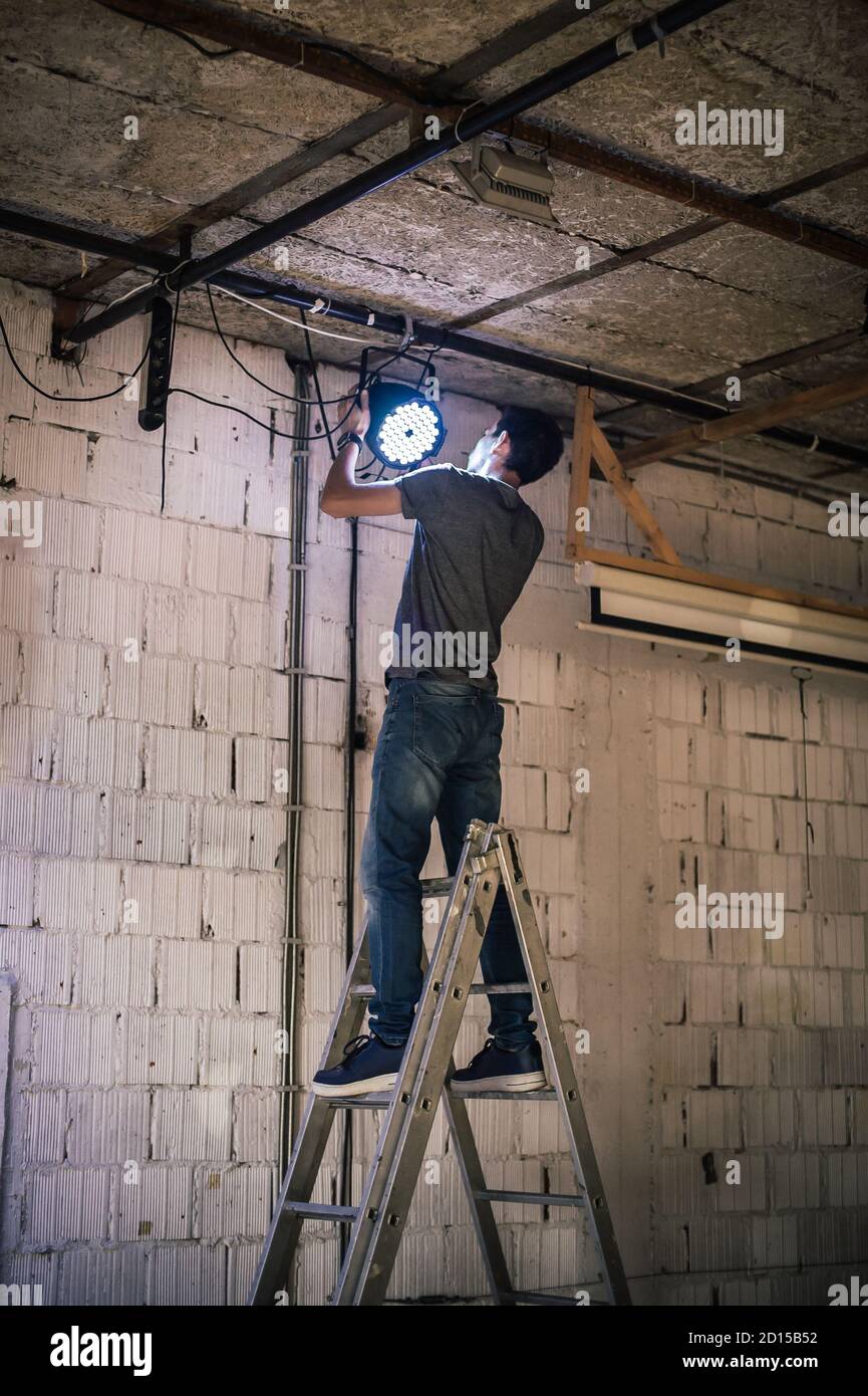 Behind the scene Lighting technician electric engineer adjusting stage