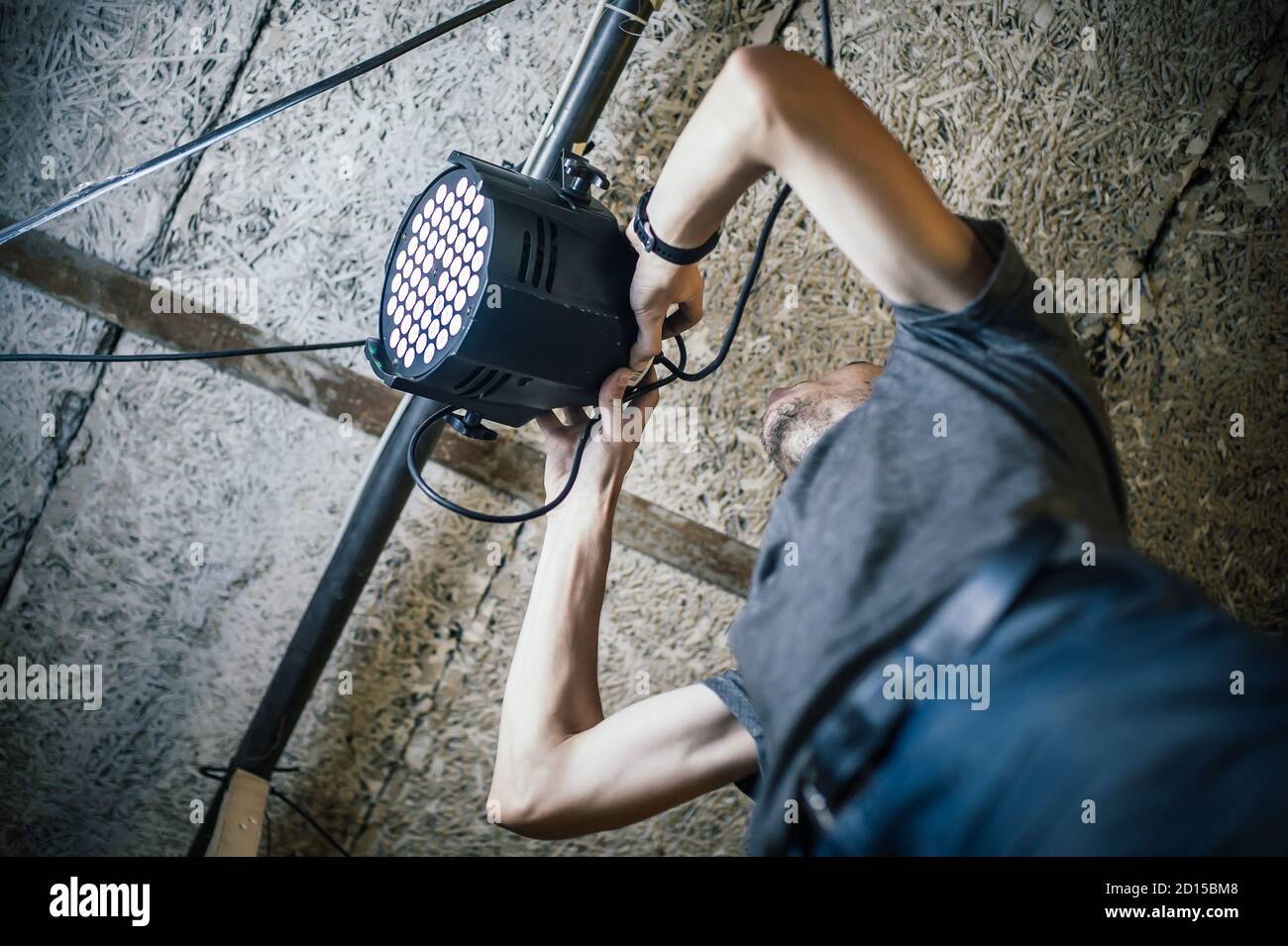 theater-lighting-technician-electric-engineer-adjusting-focus-of