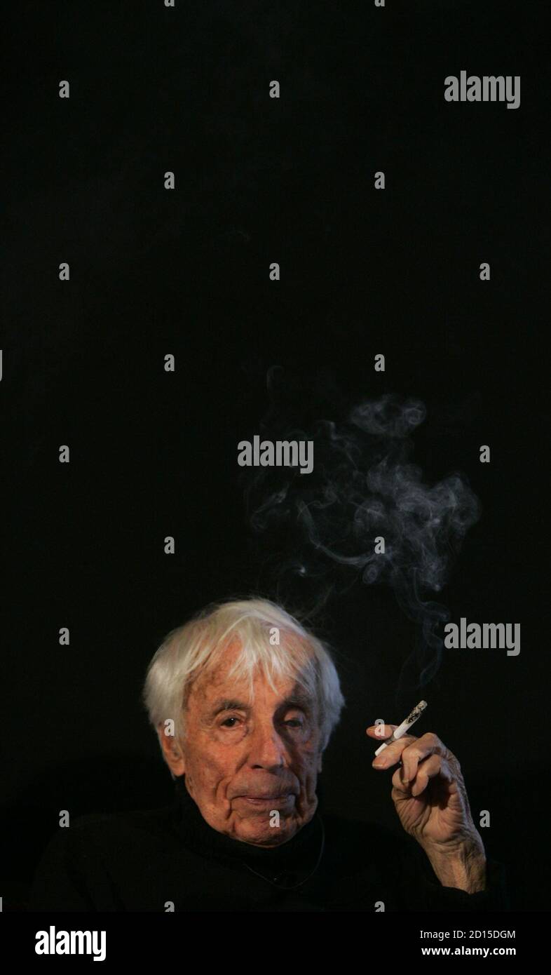 Dutch-born 102-year-old German actor and singer Johannes Heesters smokes a cigarette during the presentation of his autobiography 'Johannes Heesters - Ein Mensch und ein Jahrhundert' (A Man and a Century) in Berlin November 13, 2006. The book, written by his wife Simone Rethel-Heesters, was presented on Monday in the German capital.      REUTERS/Tobias Schwarz     (GERMANY) Stock Photo