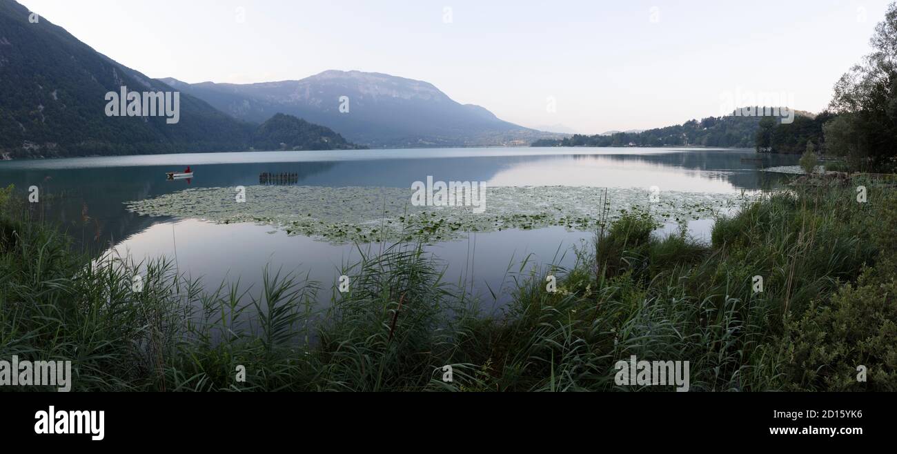 France, Savoie, Savoyard country, the lake of Aiguebelette, a little red riding hood on a boat in the early morning Stock Photo