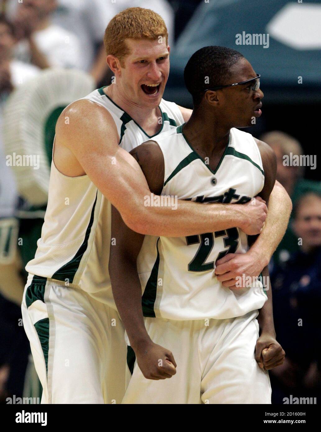 Michigan State's center Drew Naymick (L) and guard Maurice Joseph celebrate during the final minutes of their NCAA basketball game against Wisconsin Badgers in East Lansing, Michigan February 20, 2007.  REUTERS/Rebecca Cook  (UNITED STATES) Stock Photo