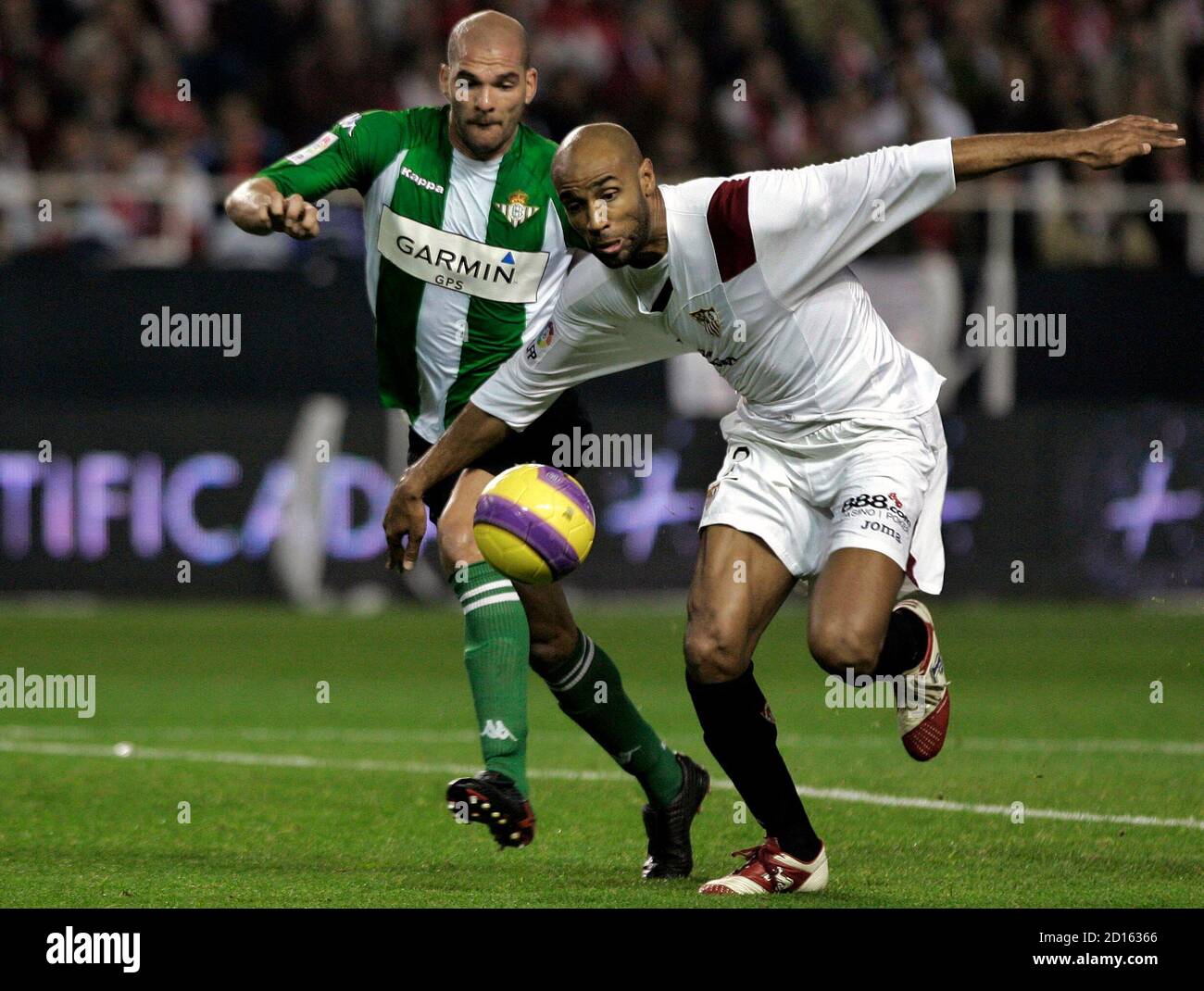 Sevilla's Frederic Kanoute (R) of Mali and Real Betis' David Rivas fight  for the ball during their Spanish first division soccer match at Ramon  Sanchez Pizjuan stadium in Seville January 6, 2008.