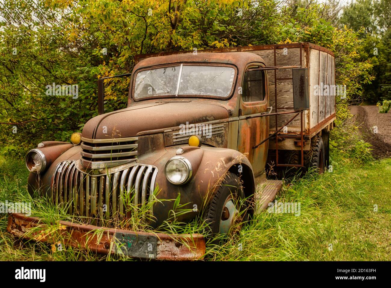 Side view of a vintage rusty truck in good shape with wooden box ...
