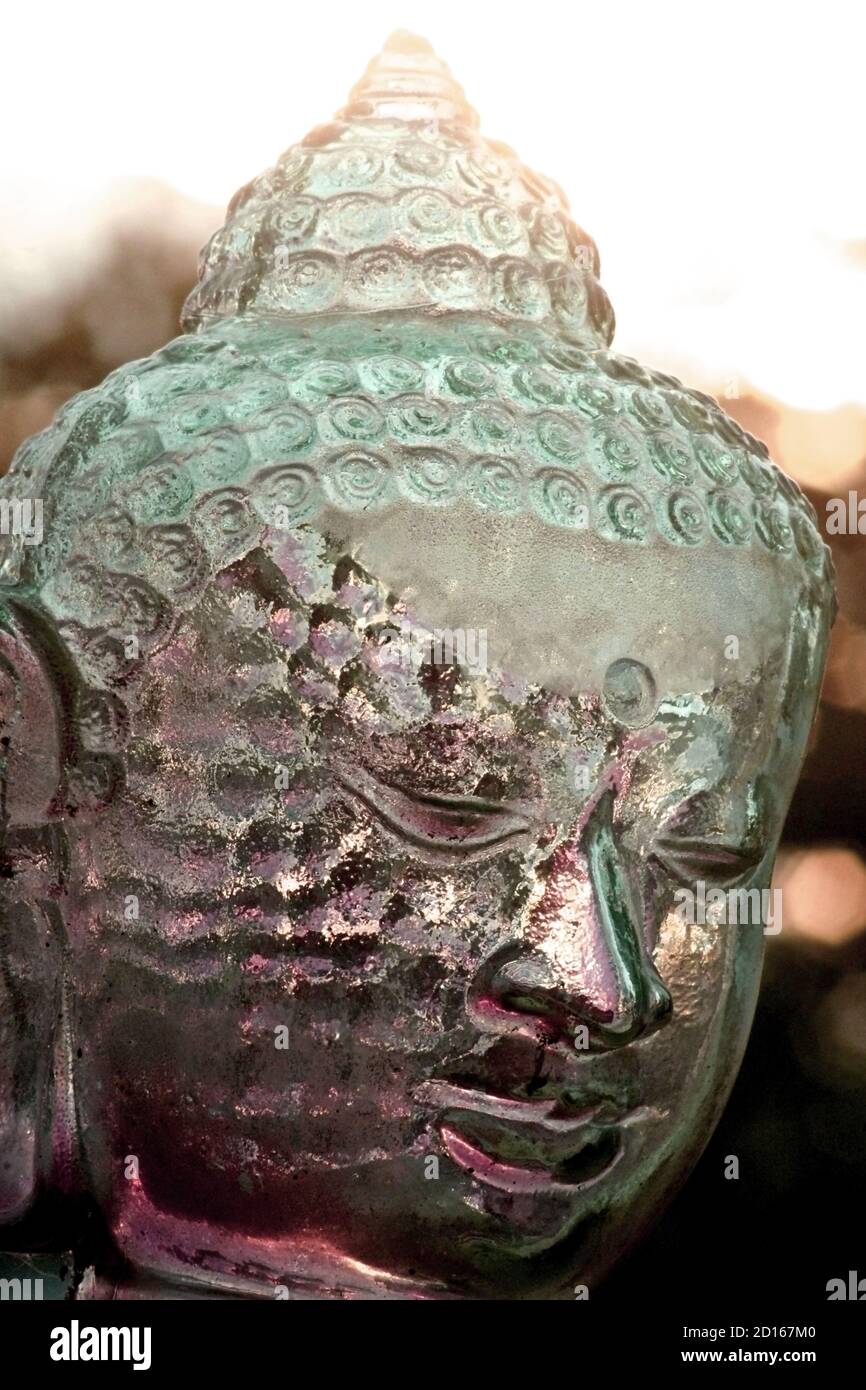 A decorative, ornamental glass head representation of Buddha, the spiritualist leader of the Buddhist philosophy. Stock Photo