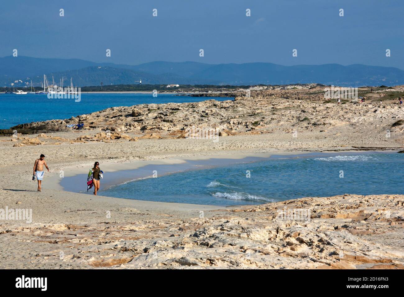 Spain, Balearic islands, formentera, platja de ses illetes, couple walking on the fine sandy beach bathed in clear water Stock Photo