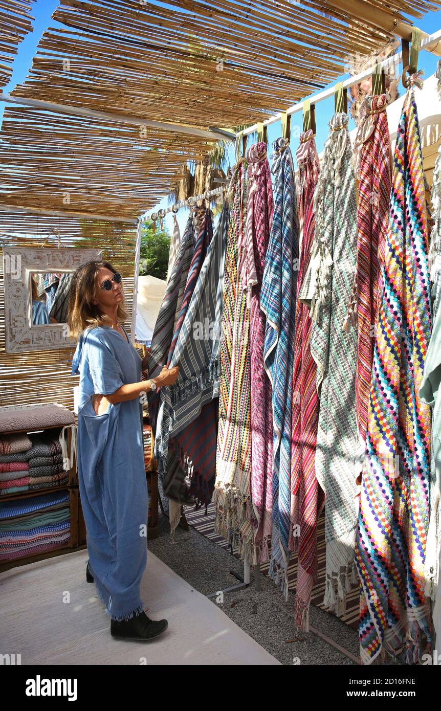 Spain, Balearic islands, Ibiza, sant carles de Peralta, woman in hippie chic dress on a hippie marcket stall of Las dalias Stock Photo
