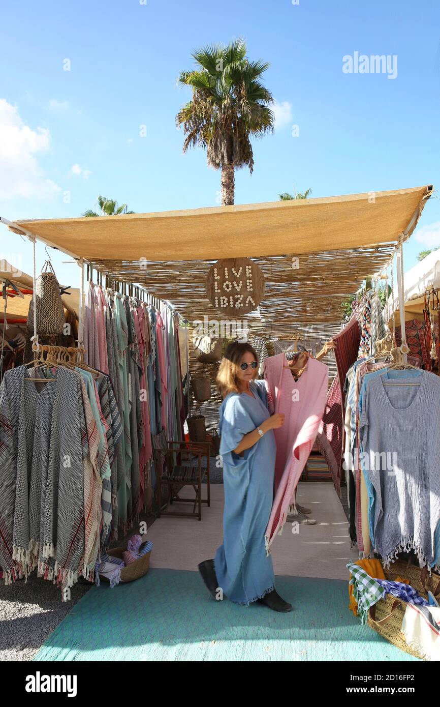 Spain, Balearic islands, Ibiza, sant carles de Peralta, woman in hippie chic dress on a hippie marcket stall of Las dalias Stock Photo