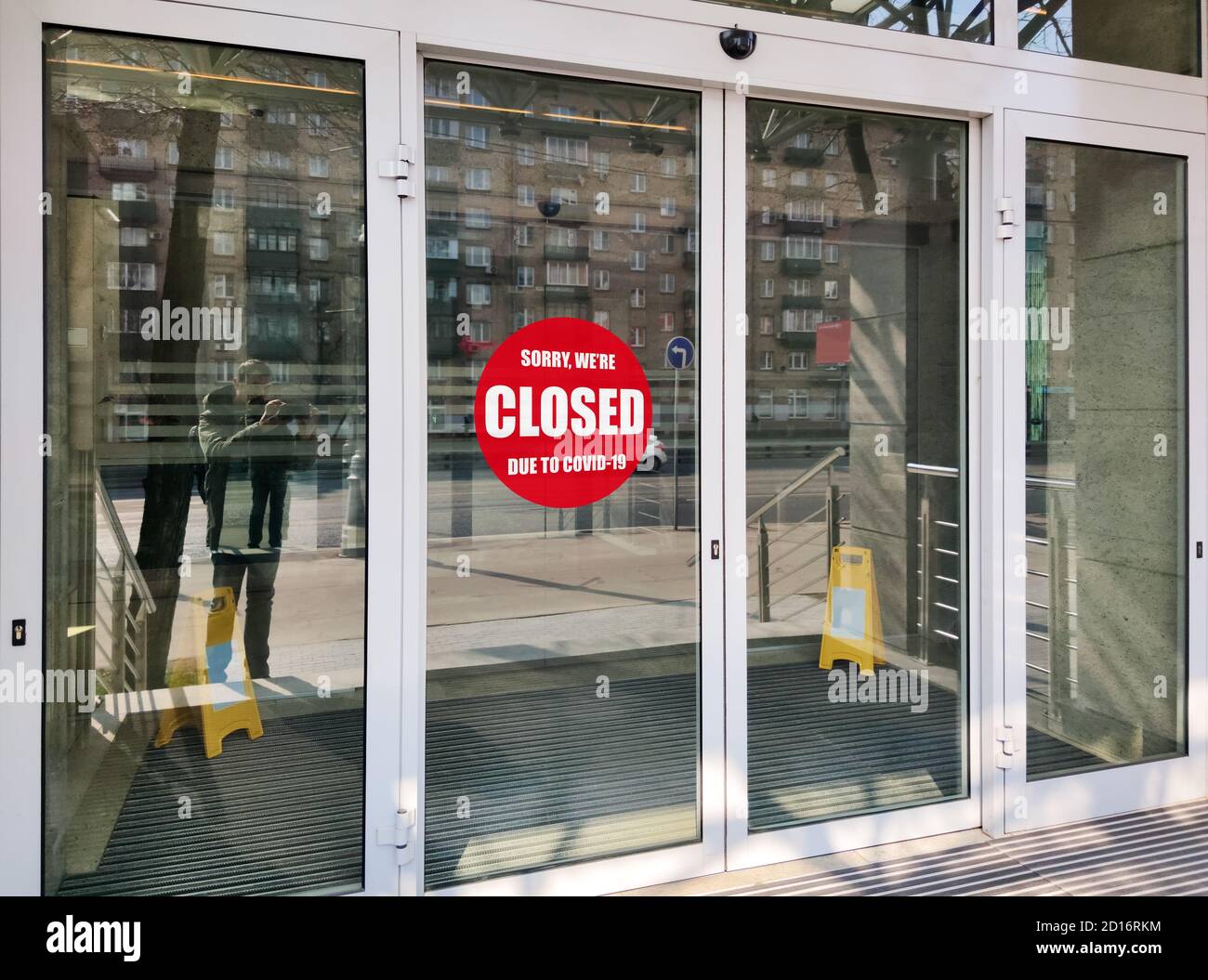 Office building closed due to COVID-19, sign with sorry in street door. Stores, restaurants, other places closed during coronavirus pandemic. Concept Stock Photo
