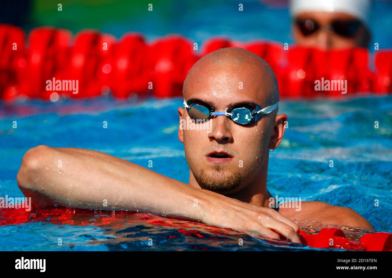 Stefan Nystrand of Sweden rests in the pool after competing in the men