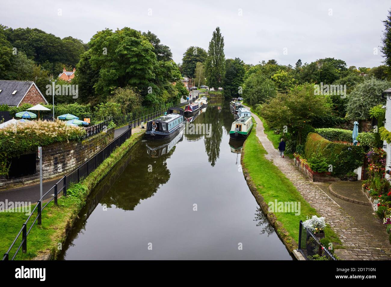 Looking down on the Bridgewater canal at Lymm village with moorings on both sides of the canal Stock Photo