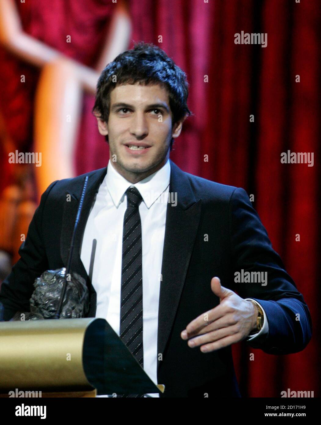 Actor Quim Gutierrez reacts upon receiving a 'Goya' award during the Spanish Film Academy 'Goya' awards ceremony in Madrid January 28, 2007. Gutierrez won the Best Upcoming Actor award for his performance in the movie 'Azul oscuro casi negro'.    REUTERS/Andrea Comas (SPAIN) Stock Photo
