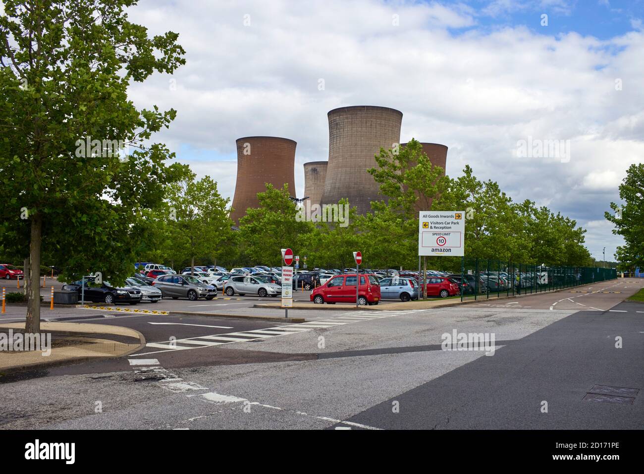 Giant cooling towers of the former coal producing powerstation above the car park for the huge Amazon warehouse in Rugely, Staffordshire Stock Photo
