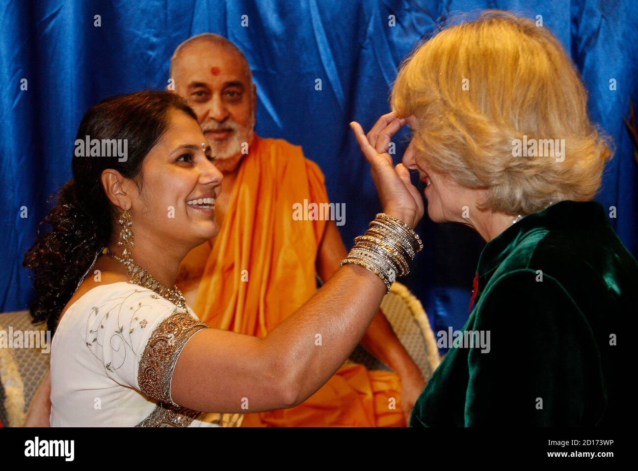 britains-camilla-duchess-of-cornwall-r-is-given-a-tikka-marking-as-she-participates-in-diwali-preparations-with-volunteers-during-a-visit-to-shri-swaminarayan-temple-in-northwest-london-november-9-2007-britains-camilla-duchess-of-cornwall-and-prince-charles-were-visiting-the-temple-for-celebration-of-the-hindu-festival-of-diwali-reuterstoby-melville-britain-2D173WP.jpg