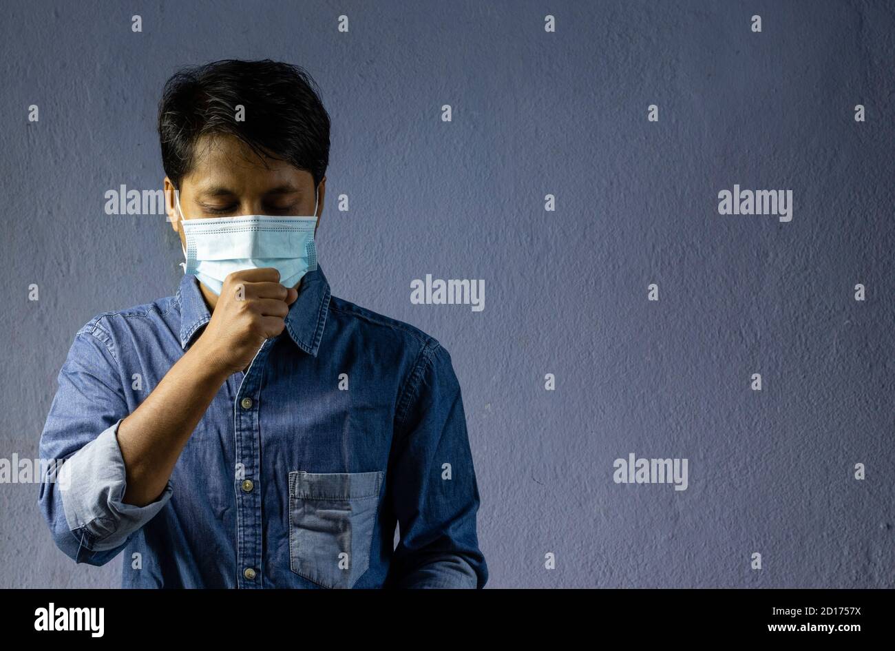 health problem and people concept - unhealthy indian man coughing with nose mask on Stock Photo