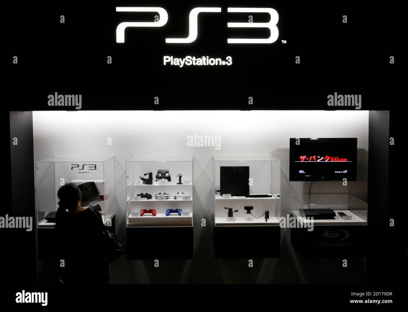 A visitor looks at a Sony's PlayStation 3 game console at the Tokyo Game  Show in Chiba, east of Tokyo, September 24, 2009. The event, which 180  exhibitors are taking part, will