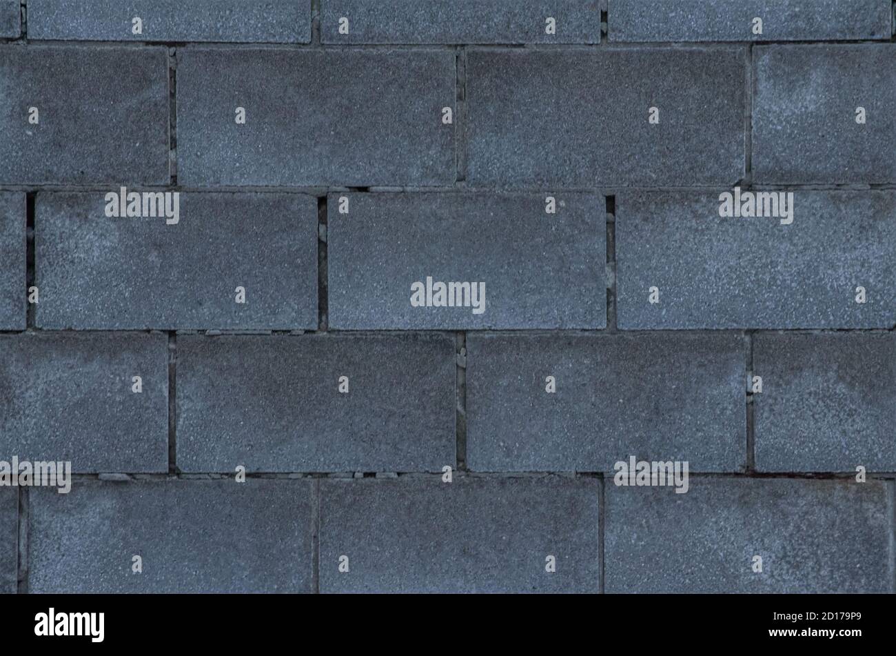Cinder block wall with gaps in between the gray bricks Stock Photo Alamy