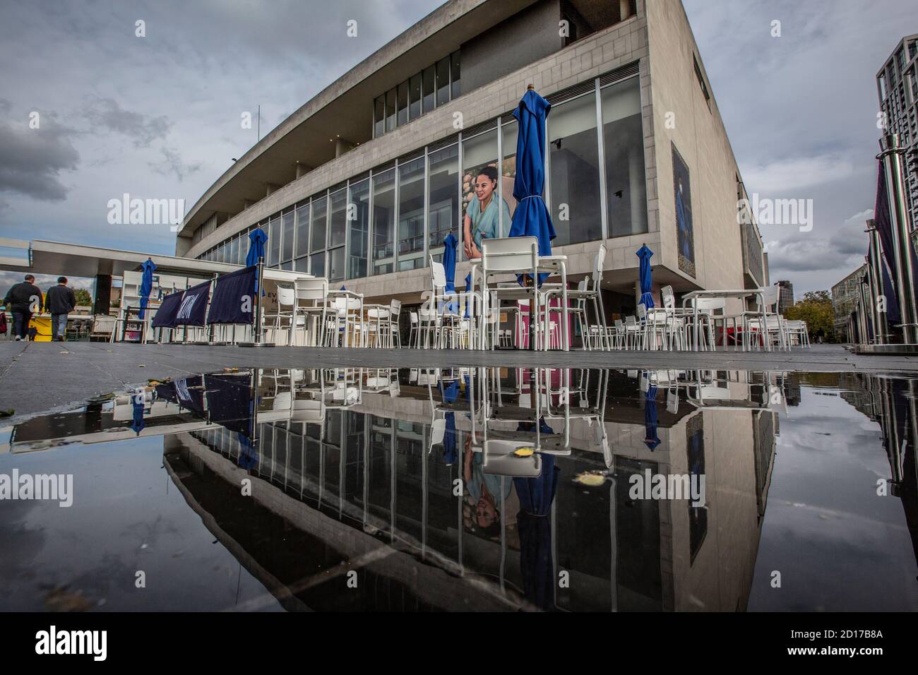 Royal Festival Hall sits empty reflected in a rain water puddle as it continues to stay closed due to coronavirus pandemic restrictions, London, UK Stock Photo
