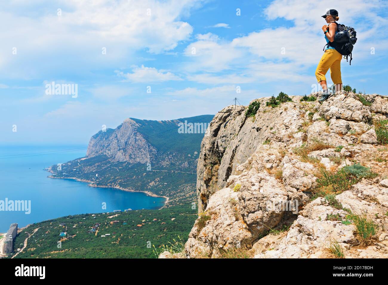 Young active woman stand on mount top. Look at amazing sea landscape. Family travel adventure, hiking activity, healthy lifestyle, exploring nature Stock Photo
