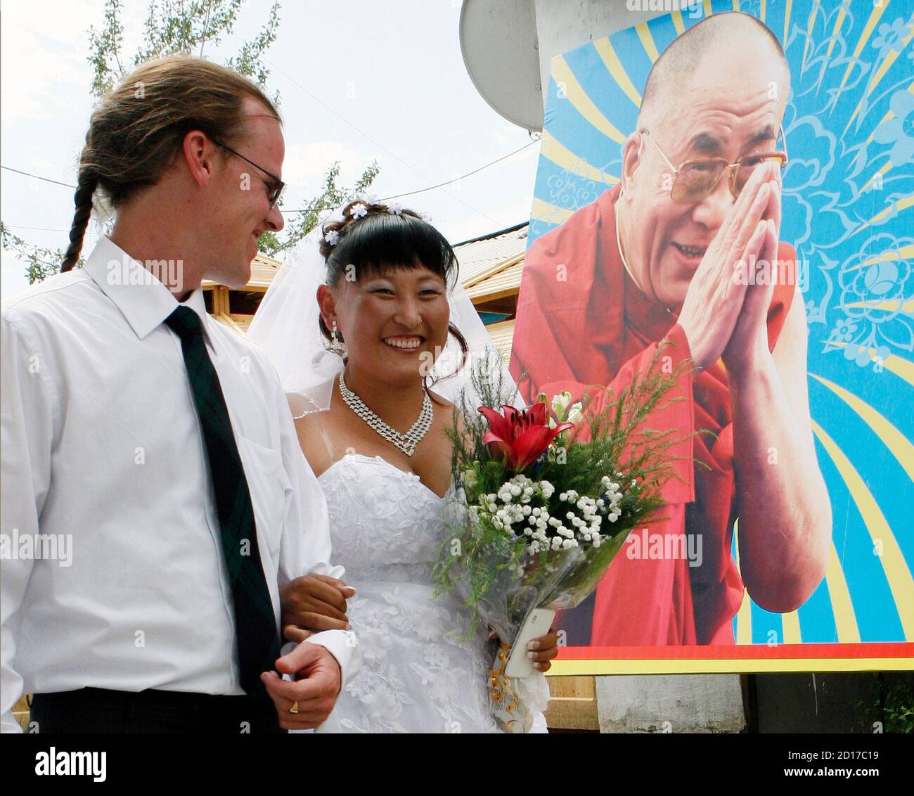 https://c8.alamy.com/comp/2D17C19/sean-quirk-l-of-us-from-milwaukee-wisconsin-and-his-bride-chaiganmaa-ondar-originally-from-tuva-walk-past-a-picture-of-tibetan-spiritual-leader-the-dalai-lama-during-their-wedding-ceremony-in-a-datsan-a-buddhist-monastery-outside-the-city-of-kyzyl-in-the-tuva-region-on-the-mongolian-border-some-736-km-457-miles-south-of-the-siberian-city-of-krasnoyarsk-july-18-2010-quirk-inspired-by-tuvan-throat-singing-moved-from-the-united-states-to-russias-tuva-region-seven-years-ago-where-he-is-currently-a-member-of-the-tuvan-national-orchestra-and-in-2008-was-named-a-merited-art-2D17C19.jpg