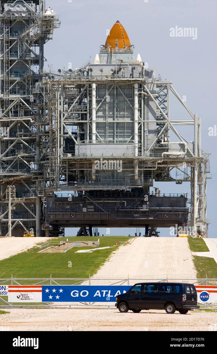 A van drives past the front of the space shuttle Atlantis as it sits on pad  39B at the Kennedy Space Center in Cape Canaveral, Florida September 4,  2006. NASA plans to