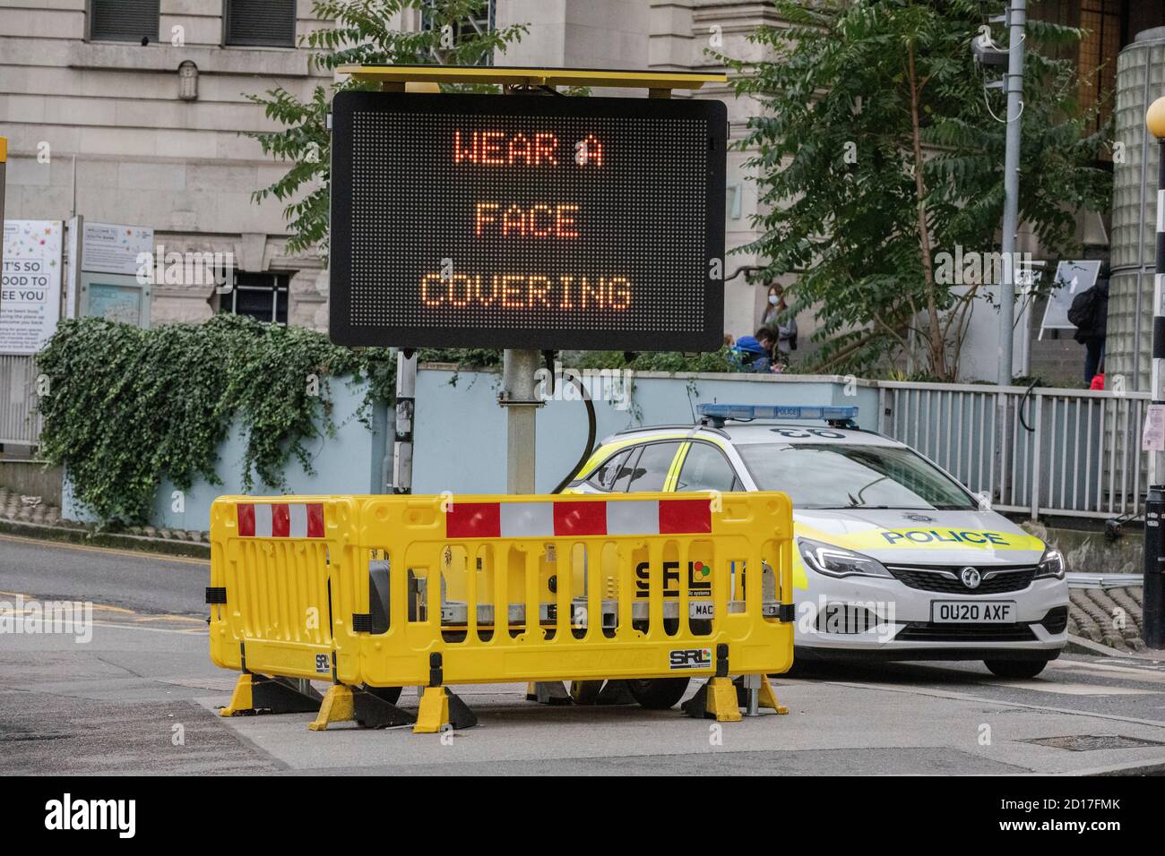 'Wear A Face Covering' advisory sign instructing commuters to wear a