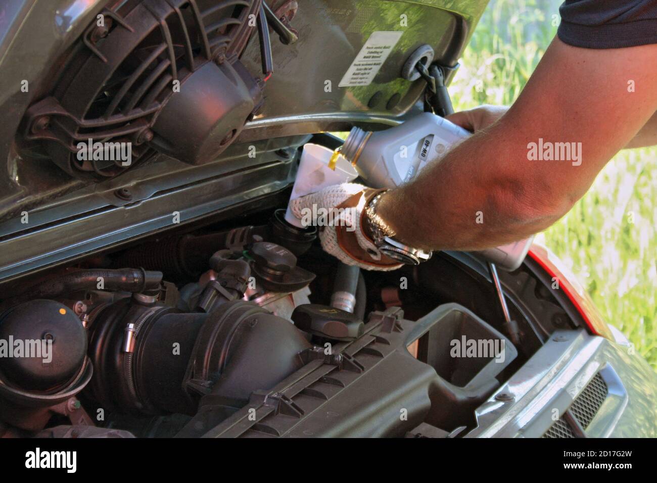 Vehicle engine oil refill, car maintenance Stock Photo Alamy