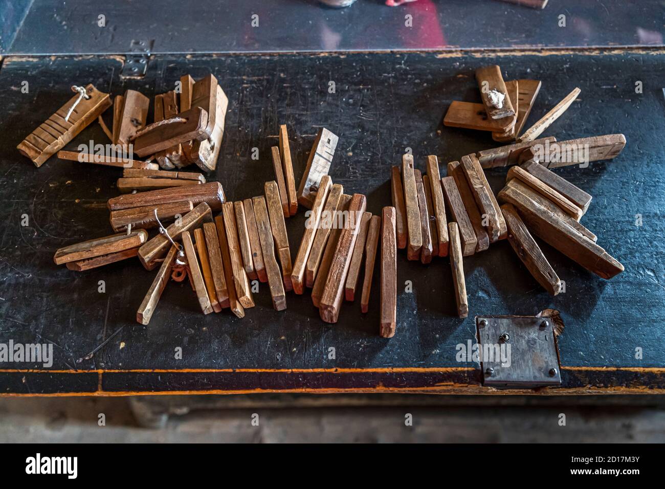 Chain with wooden marker symbols defining the order of water rights. These "Tessels" are wooden documents, i.e. pieces of wood or wooden sticks with the notched house sign of a particular person. Visperterminen Museum of local history, Valais, Switzerland Stock Photo