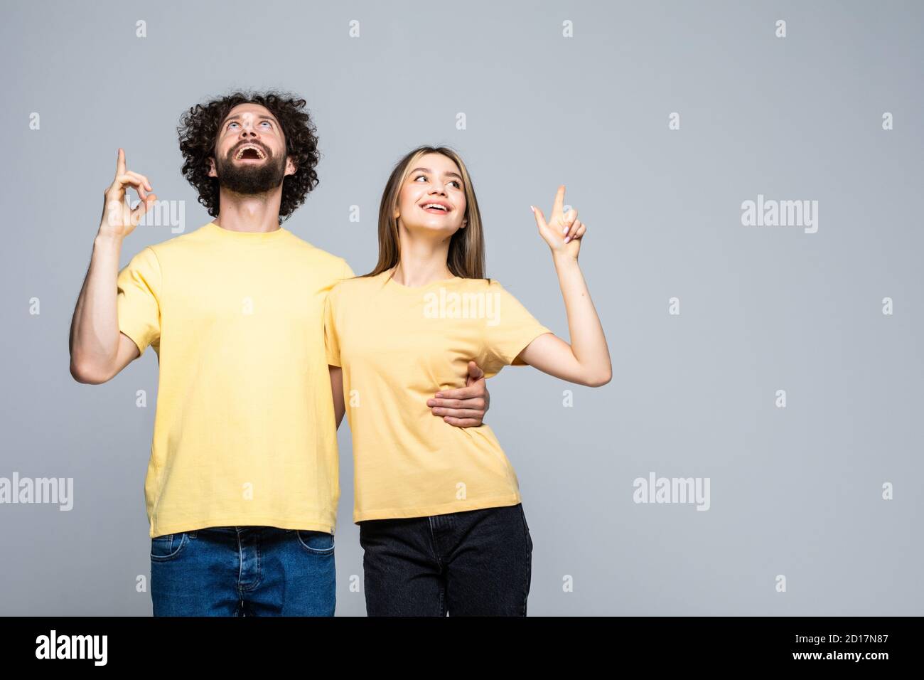 Excited happy young couple winners celebrate win motivated by triumph rejoice victory success together isolated on white grey background Stock Photo