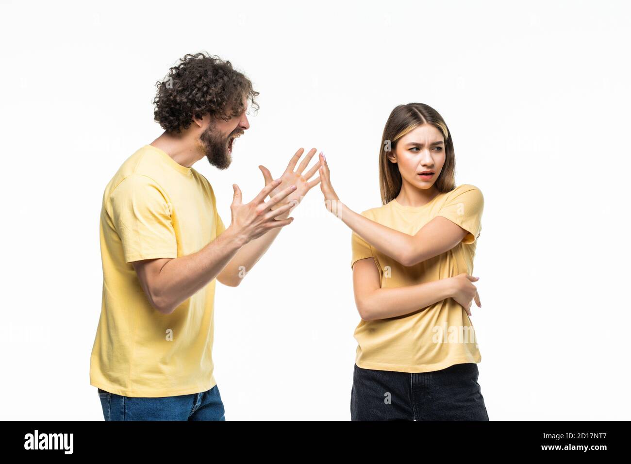 Closeup portrait of young angry couple, man, woman, screaming at each other, blaming for problem, isolated on white background. Marriage difficulties Stock Photo