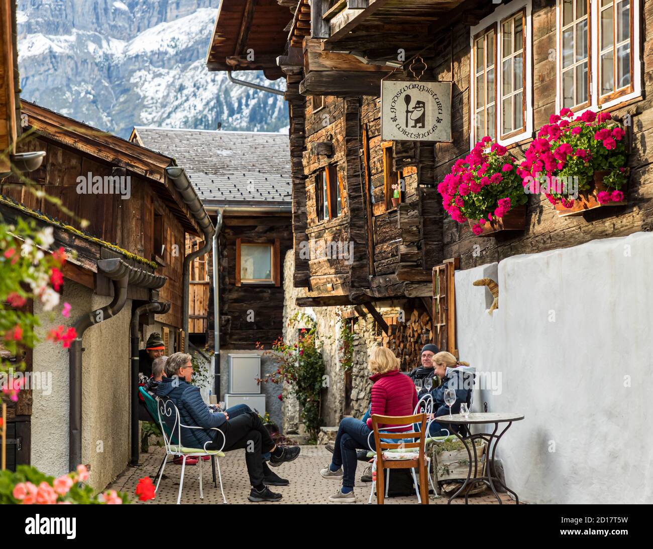 The Godswärgistubu in Albinen is a very beautiful historic Valais restaurant and offers seasonal dishes from its own garden or from what grows in the fields, forests and meadows in the region. Guided herbal hike through Albinen in Valais, Switzerland Stock Photo